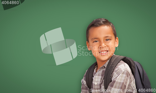 Image of Cute Hispanic Boy In Front of Blank Chalk Board