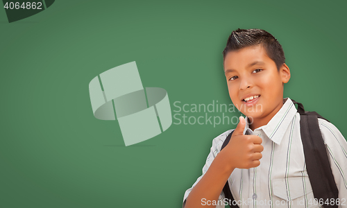 Image of Cute Hispanic Boy In Front of Blank Chalk Board