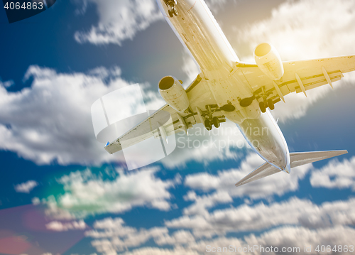 Image of Jet Airplane Landing with Dramatic Clouds Behind