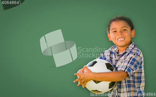 Image of Cute Young Mixed Race Boy Holding Soccer Ball In Front of Blank 