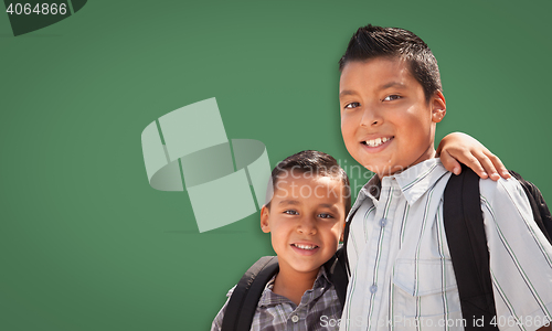 Image of Cute Hispanic Boys In Front of Blank Chalk Board