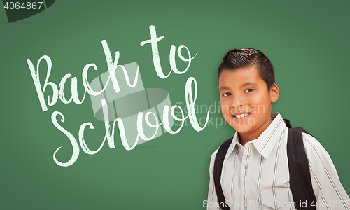 Image of Hispanic Boy In Front of Back To School Chalk Board