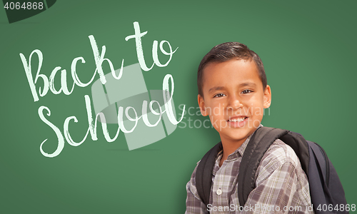 Image of Hispanic Boy In Front of Back To School Chalk Board