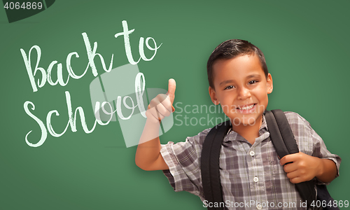 Image of Thumbs Up Hispanic Boy in Front of Back To School Chalk Board