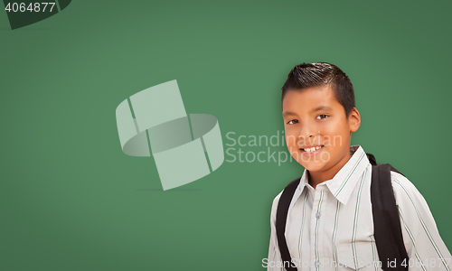 Image of Cute Hispanic Boy In Front of Blank Chalk Board