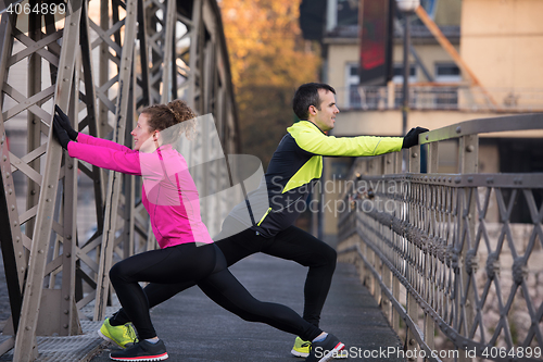 Image of couple warming up before jogging