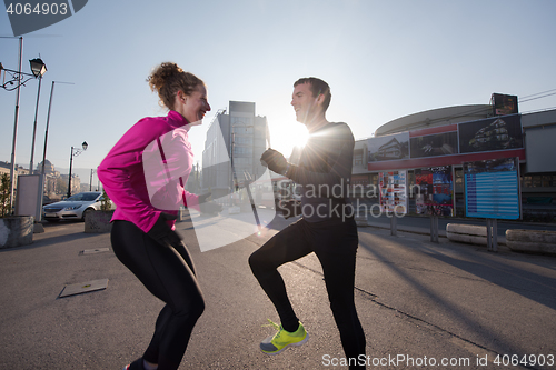 Image of couple warming up before jogging