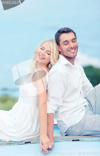 Image of smiling couple at sea side