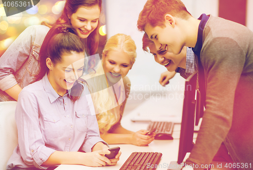 Image of students with computer monitor and smartphones