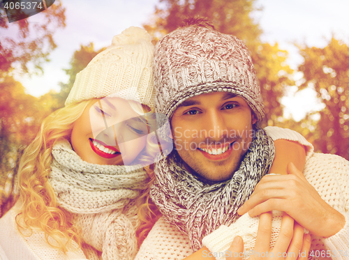 Image of happy couple in warm clothes over autumn