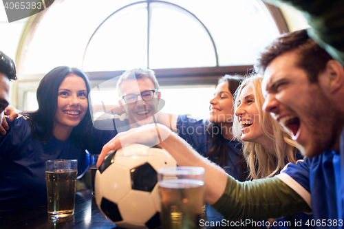 Image of football fans or friends with beer at sport bar