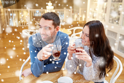 Image of happy couple drinking tea at cafe