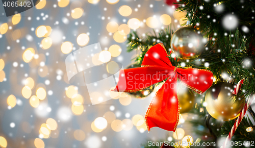 Image of close up of red bow decoration on christmas tree