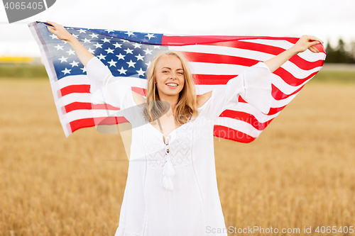 Image of happy woman with american flag on cereal field