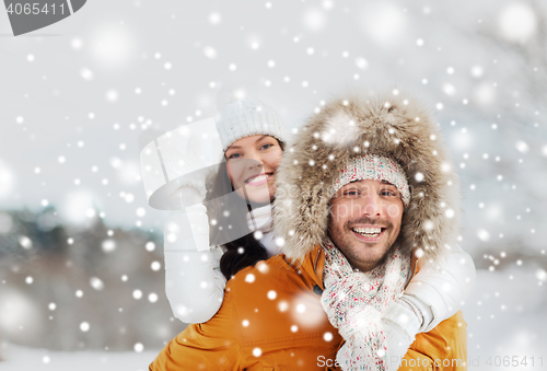 Image of happy couple having fun over winter background