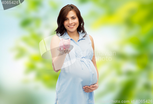 Image of happy pregnant woman with piggybank