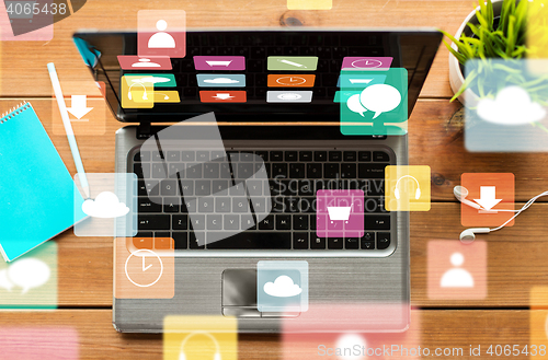 Image of close up of laptop on wooden table with menu icons