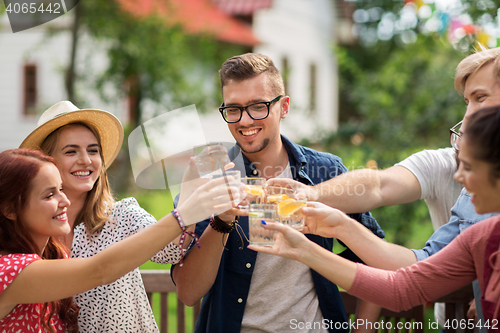 Image of happy friends clinking glasses at summer garden