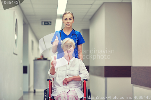 Image of nurse with senior woman in wheelchair at hospital