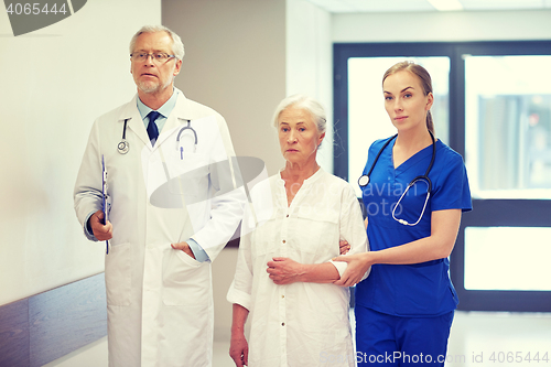 Image of medics and senior patient woman at hospital