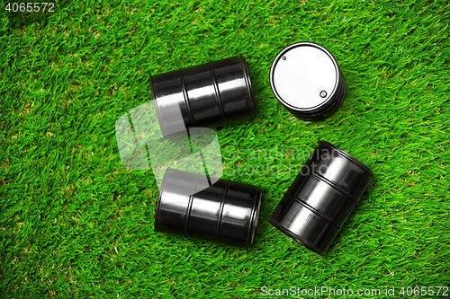 Image of High angle view on four oil barrels on a grass