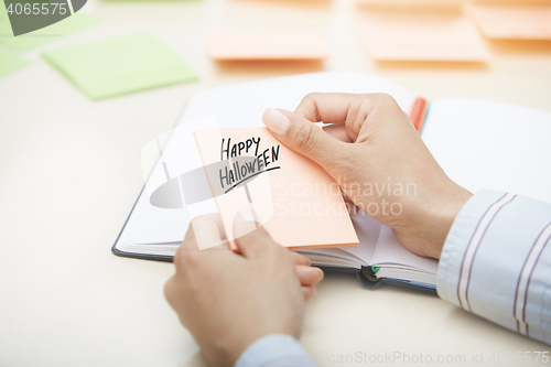 Image of Happy Halloween agenda in hands