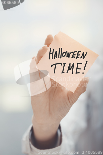 Image of Woman holding agenda with Halloween time text