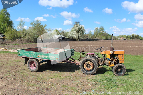 Image of tractor with trailer in the village