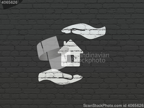 Image of Insurance concept: House And Palm on wall background