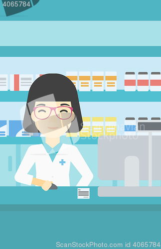 Image of Pharmacist at counter with computer monitor.