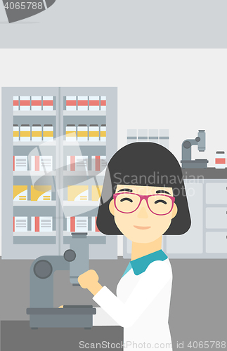 Image of Laboratory assistant with microscope.