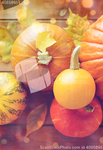 Image of close up of pumpkins on wooden table at home