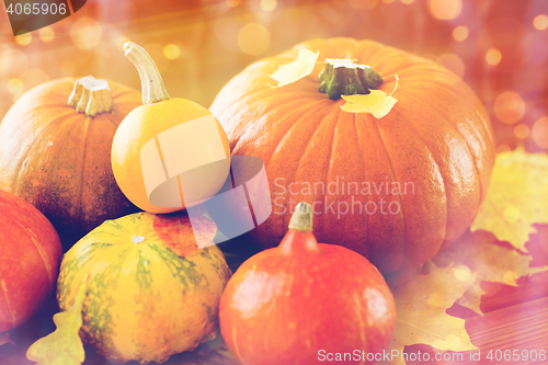 Image of close up of pumpkins on wooden table at home