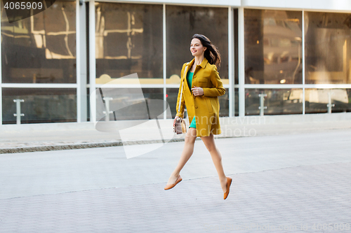 Image of happy young woman or teenage girl on city street