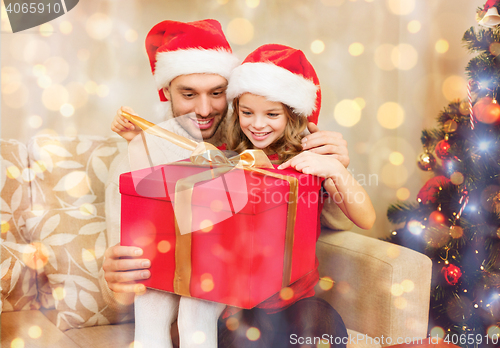 Image of smiling father and daughter opening gift box