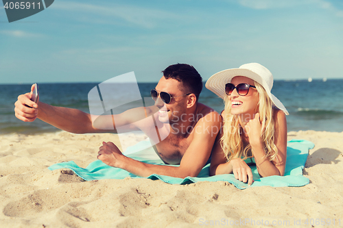 Image of happy couple in swimwear walking on summer beach