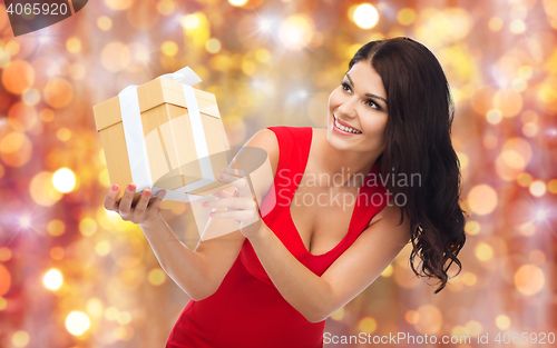 Image of beautiful sexy woman in red dress with gift box