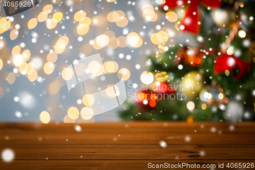 Image of empty wooden surface over christmas tree lights