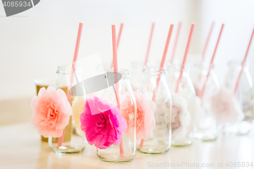 Image of close up of glass bottles for drinks with straws