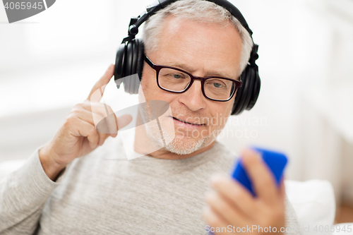 Image of happy senior man with smartphone and headphones