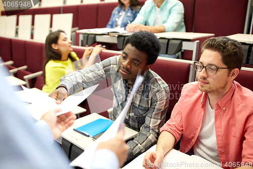 Image of teacher giving tests to students at lecture