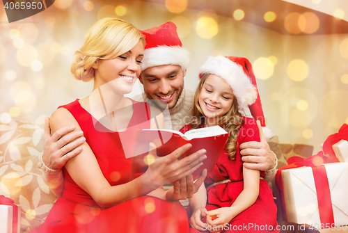 Image of smiling family reading book