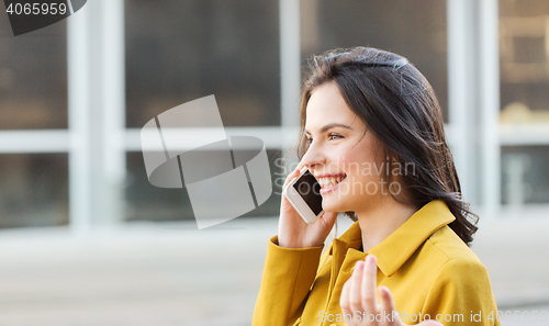 Image of smiling young woman or girl calling on smartphone