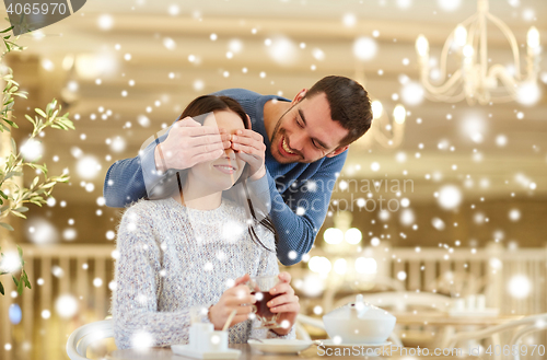 Image of happy couple drinking tea at cafe