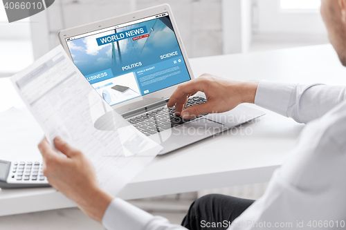 Image of businessman with laptop computer working at office