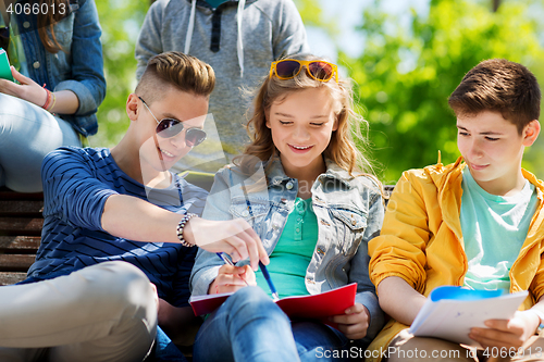 Image of group of students with notebooks at school yard