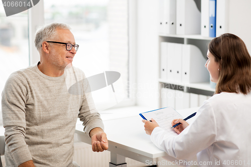 Image of senior man and doctor meeting at hospital