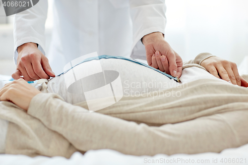 Image of close up of doctor and pregnant woman at hospital