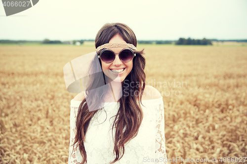 Image of smiling young hippie woman on cereal field