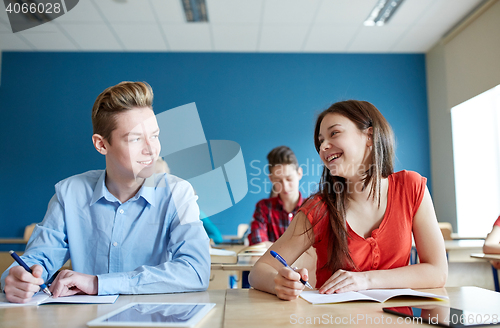 Image of group of happy students talking at school lesson